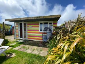 a colorful tiny house in a garden at Sunrise Cabin in Carbis Bay