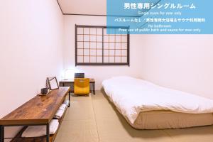 Postel nebo postele na pokoji v ubytování サウテル宇都宮芳賀