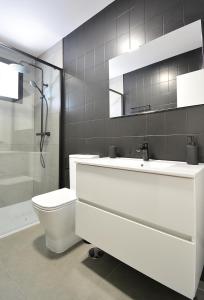 a bathroom with a toilet and a sink and a shower at Roma's Apartment in Cambados