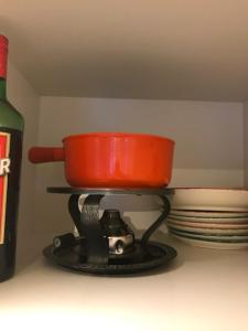 a pot on a stove with plates and a bottle of wine at Bad Ragaz Appartement in Bad Ragaz