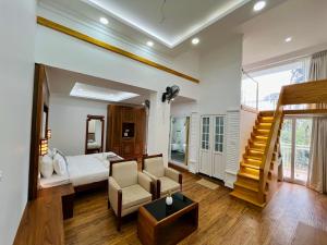 a large bedroom with a bed and a stair case at HOTEL WHITE HOUSE, Munnar in Munnar