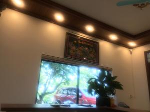 Habitación con ventana y coche rojo en el exterior en Hải Lê Tam Coc Happy Homestay, en Ninh Binh