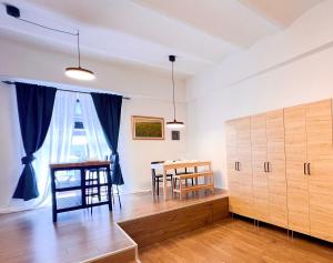 a living room with a table and a dining room at Aumetz square apartment in Idrija