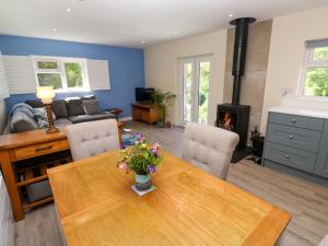 a living room with a wooden table and a fireplace at Chy-An-Oula in Falmouth
