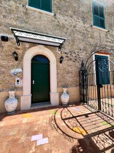 ein Gebäude mit einer Tür und zwei Vasen davor in der Unterkunft Il Sogno in Erchie