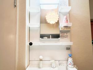 a bathroom with a mirror above a sink at 池袋2分 3Rooms 6人可 in Tokyo