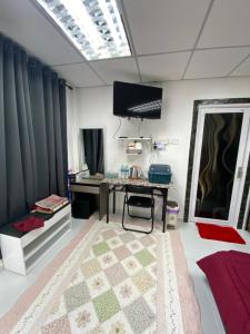 a room with a desk and a table and a mirror at ROOMSTAY NIMAZA Bilik 1 in Marang