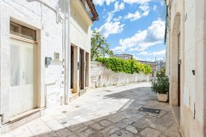 an empty street in an old town with trees at Casa Cenzina by Rentbeat in Locorotondo