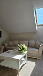 a living room with a couch and a coffee table at Hotel nad Pilicą in Przedbórz