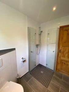 a bathroom with a shower with a glass door at Premium-Ferienhaus - Extertal Ferienpark - #36 in Extertal