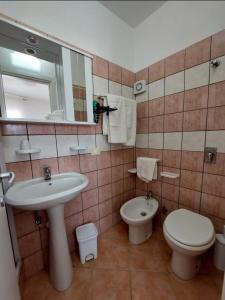 a bathroom with a sink and a toilet and a mirror at Appartamenti Da Nicola in Lampedusa