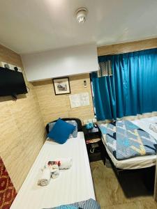 Un pat sau paturi într-o cameră la Philippine Hostel