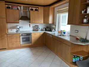 a kitchen with wooden cabinets and a stove top oven at Privatquartier im Ortskern von Westerstede in Westerstede