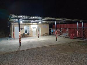 a large open garage at night with a building at ROOMSTAY NIMAZA Bilik 1 in Marang