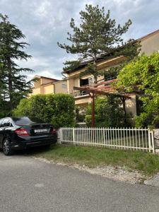 a black car parked in front of a house at Nona - 200m from the beach in Jadranovo