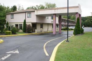 an empty street in front of a building at Express Inn - Wall in Farmingdale