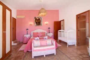 a pink bedroom with a bed and two tables at Country House Casa Da Avó in Loulé +27 photos