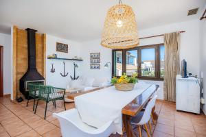 a dining room with a table and a fireplace at Ran de Mar in Son Serra de Marina +26 photos