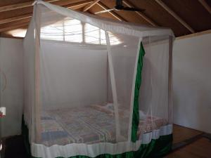 a bed in a room with a canopy at Yoga Culture Palolem in Palolem