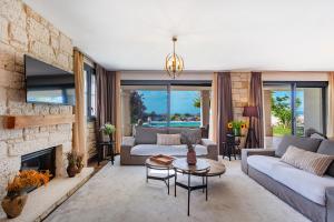 a living room with a couch and a fireplace at VillaSunset with Magnificent Sea View in Çeşme
