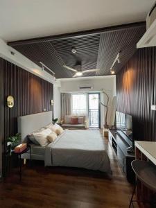 马尼拉Muji-Inspired hōme-tél in the heart of Makati的带一张大床和一张沙发的卧室