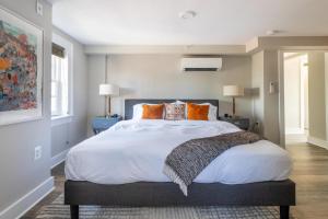 a bedroom with a large bed with orange pillows at Alexandria West 2br w wd nr dining WDC-769 in Alexandria