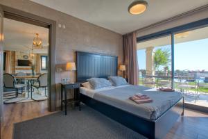 a bedroom with a large bed and a balcony at VillaSunset with Magnificent Sea View in Çeşme