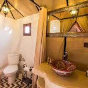 a bathroom with a sink and a toilet at desert indigo luxury camp in Merzouga