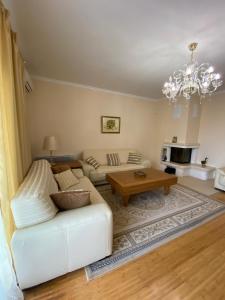 a living room with a white couch and a table at Casa di mare 5 in Petrovac na Moru +36 photos
