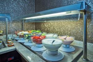 a buffet line with bowls of food on a counter at Laleli Gonen Hotel in Istanbul