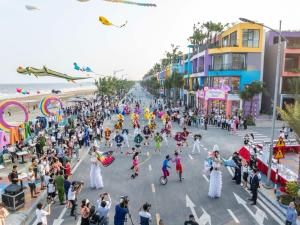 a large crowd of people flying kites on a street at Flamingos Hải Tiến in Nam Khê +18 photos