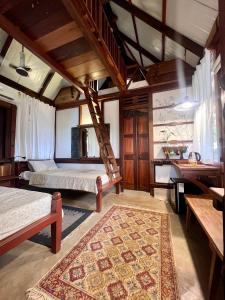 a bedroom with two beds and a staircase at Svarna in Udupi