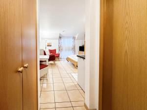 a hallway with a living room and a living room with a roomswersswersswers at FeWo StrandDomicil21 in Dahme