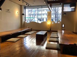 a large room with a large wooden table and a large window at Sky Hotel in Matsuyama