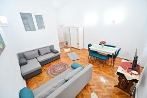 a living room with a couch and a table at FLH - Maria Grand Square Apartment in Sibiu