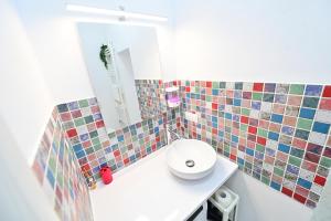 a bathroom with a white sink and a mirror at FLH - Maria Grand Square Apartment in Sibiu +19 photos