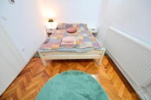 a small room with a table and a rug at FLH - Maria Grand Square Apartment in Sibiu