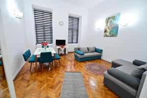 a living room with a couch and a table at FLH - Maria Grand Square Apartment in Sibiu