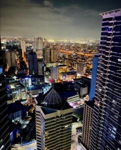 an aerial view of a city at night at Muji-Inspired hōme-tél in the heart of Makati in Manila