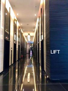 a hallway of a building with a lift sign on it at Muji-Inspired hōme-tél in the heart of Makati in Manila