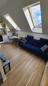 a living room with a blue couch and a table at Apartamenty Nowickiego in Lublin