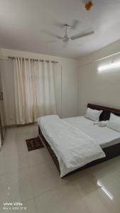 a bedroom with two beds and a ceiling at Osho home stay in Lucknow