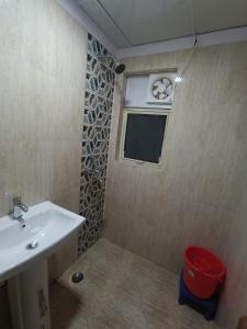 a bathroom with a sink and a window at Osho home stay in Lucknow