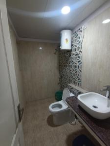 a bathroom with a toilet and a sink at Osho home stay in Lucknow