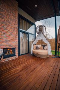 a porch with a hammock and a fireplace at Vital Göl Sapanca Isıtmalı Havuzlu Bungalov & Villa in Sapanca