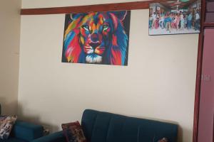 a painting of a lion hanging on a wall at Home Waka in Wakiso
