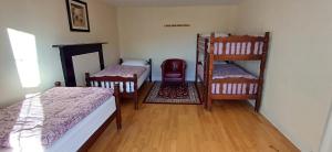 a room with two bunk beds and a mirror at Fáilte Lodging Kenmare Town Centre in Kenmare