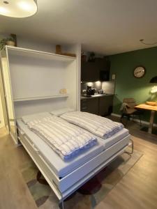 キュールングスボルンにあるStrandstrasse-32-App-41の緑の壁の客室の白いベッド1台
