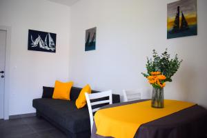 a living room with a yellow table and a couch at Apartments Maestral in Malinska