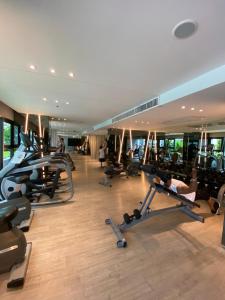 a gym with several people exercising on tread machines at The base in pattaya condo in Pattaya Central